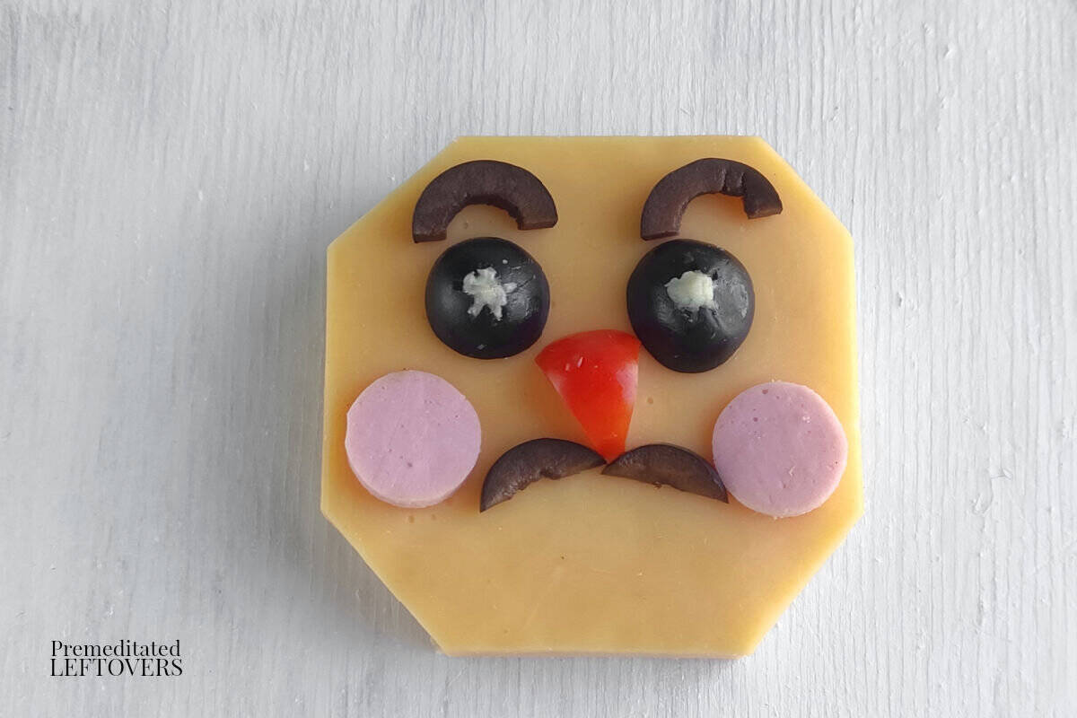 nutcracker face made with cheese and olives