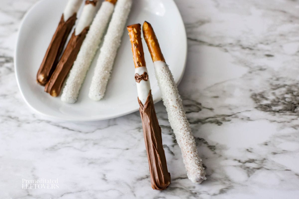 chocolate covered wedding pretzel rods that look like a bride and groom