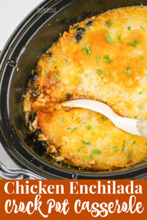 chicken enchilada casserole that is done cooking in a crock pot