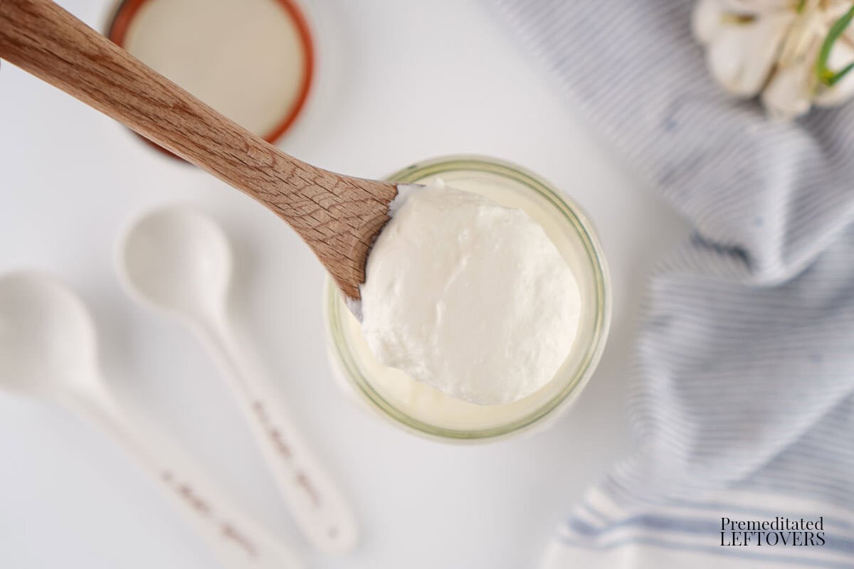 A spoonful of thick, creamy Homemade Sour Cream Recipe that's so easy to make in your very own kitchen