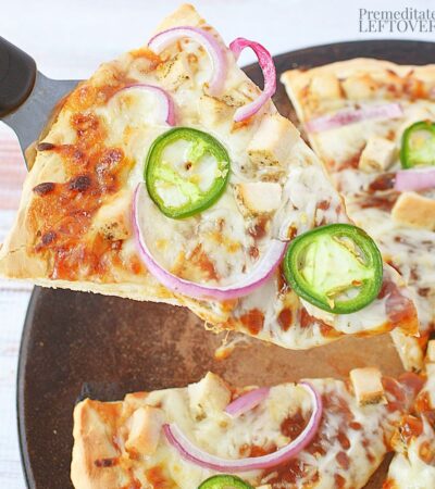 A slice of barbecue chicken pizza, ready to eat.