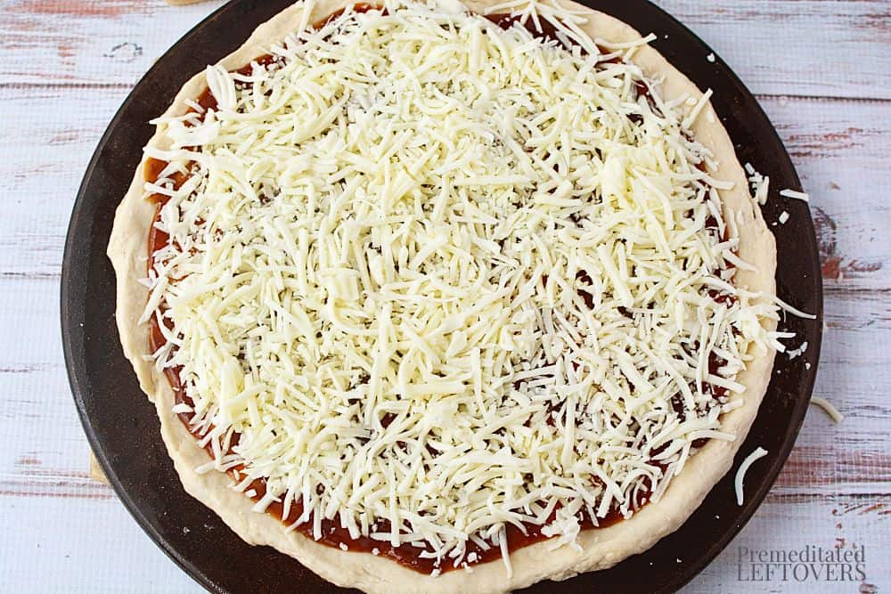 Shredded mozarella cheese on top of the barbecue sauce